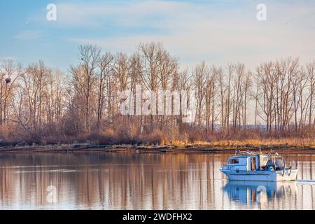Small commercial fish boat returning to Steveston in British Columbia Canada Stock Photo