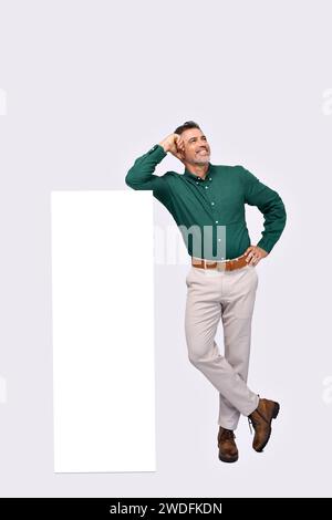 Happy mature business man standing near big mobile phone mockup screen. Stock Photo