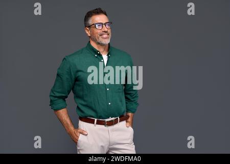 Happy middle aged business man wearing green shirt and stylish eyeglasses. Stock Photo