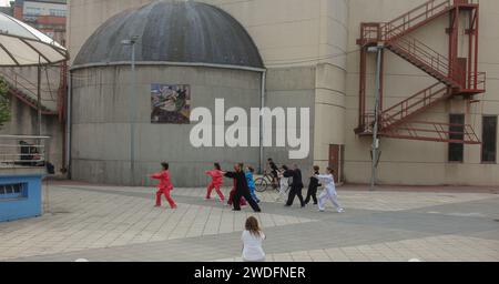 Burela, Spain - 05 05 2022: several people practicing taichi in a square to promote it Stock Photo