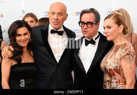 Munich, Germany. 20th Jan, 2024. 48th German Film Ball: Actors Heiner Lauterbach (2nd from left), with his wife Viktoria Lauterbach (left), Jan Josef Liefers (2nd from right) and Anna Loos walk down the red carpet to the event. The German Film Ball takes place again for the first time after the Corona break. Credit: Felix Hörhager/dpa/Alamy Live News Stock Photo