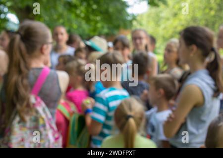 group of schoolchildren children on a tour of the nature of a blurred background Stock Photo