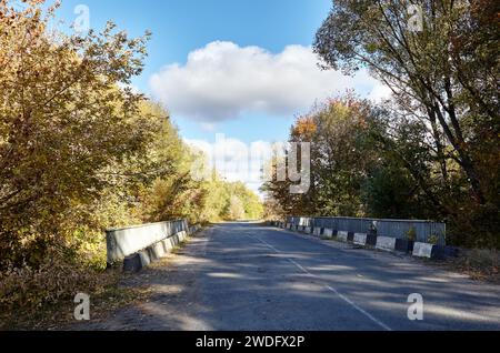 Barrier, designed to prevent the exit of the vehicle from the curb or bridge. Guarding rail on suburban road Stock Photo