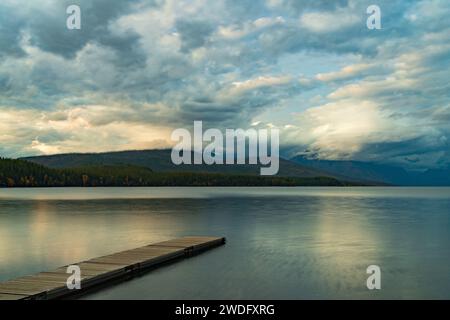 Sunset on Lake McDonald with reflections and dock, Glacier National Park, Montana, USA. Stock Photo