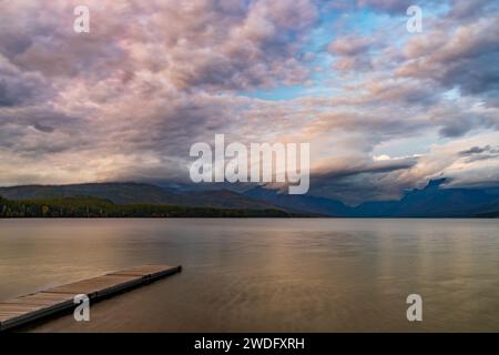 Sunset on Lake McDonald with reflections and dock, Glacier National Park, Montana, USA. Stock Photo