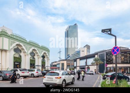 Modern and traditional decorated buildings with parked cars in the foreground on the downtown street of Al Khobar, Saudi Arabia Stock Photo