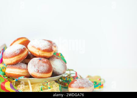 Colourful streamers and doughnuts, carnival, copy room, white background Stock Photo