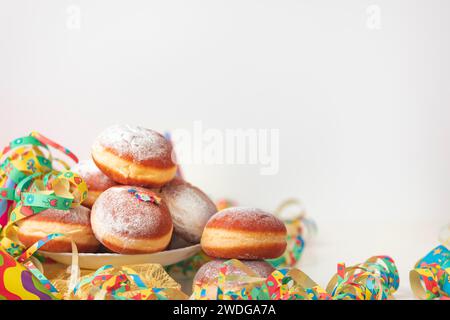 Colourful decoration and doughnuts, carnival table, copy room, white background Stock Photo