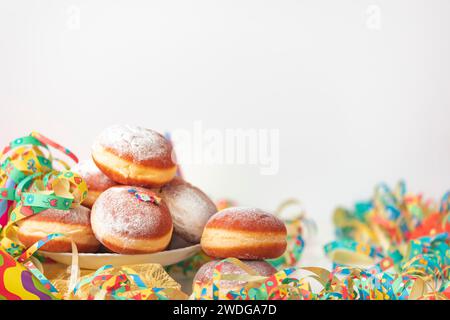 Colourful decoration and doughnuts, carnival table, copy room, white background Stock Photo