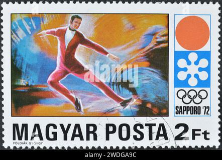 Cancelled postage stamp printed by Hungary, that shows Figure skating, promoting Winter Olympics in Sapporo, circa 1972. Stock Photo