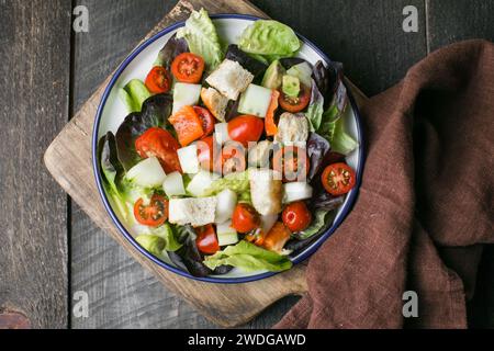 Traditional italian tomato salad panzanella with mozzarella, capers, red onion and croutons. Summer salad. Top view, flat lay Stock Photo