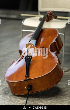 A cello instrument placed on a chair Stock Photo