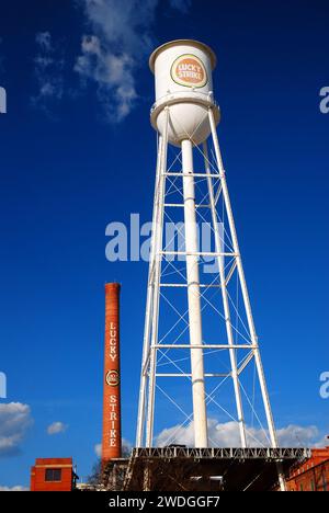 The smoke stack and water tower still bear the name of a cigarette brand over the former tobacco factory, now an entertainment district Stock Photo