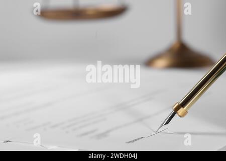 Signing document with fountain pen at table, closeup and space for text. Notary contract Stock Photo