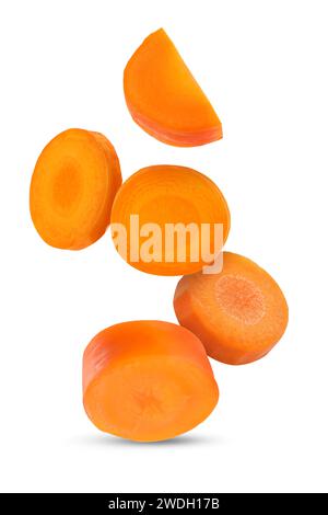 Fresh carrot slices falling on white background Stock Photo
