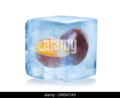 Frozen food. Raw plums in ice cube isolated on white Stock Photo