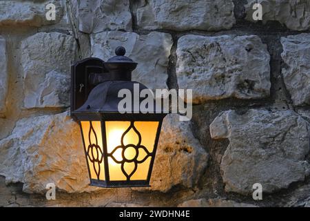Streetlight lantern on stone wall Stock Photo