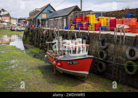 Mevagissey, Cornwall, England, UK - May 29, 2022: Ships in the harbour at low tide Stock Photo