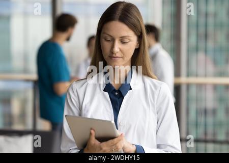 Focused young doctor woman using healthcare online service Stock Photo