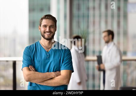 Happy handsome surgeon man looking at camera with toothy smile Stock Photo
