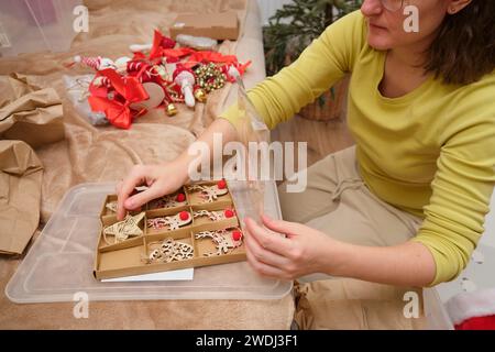 Cleaning up Christmas tree decorations in the home room after Christmas is over. Preparing for the New Year's celebration and unpacking the decor Stock Photo