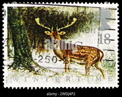 MOSCOW, RUSSIA - DECEMBER 23, 2023: Postage stamp printed in United Kingdom shows Common Fallow Deer (Dama dama), The Four Seasons: Wintertime serie, Stock Photo