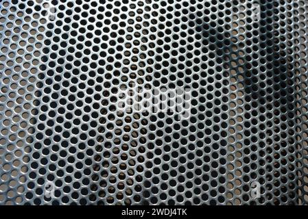 Metal mesh, background, with round identical holes, metal structure. Stock Photo