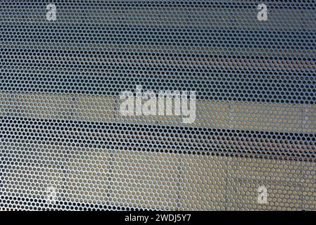 Metal mesh, background, with round identical holes, metal structure. Stock Photo