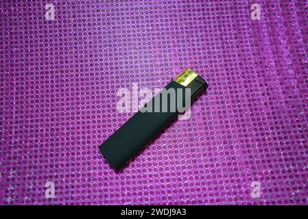 Green slide of colored tablets, on pink reflective background Stock Photo