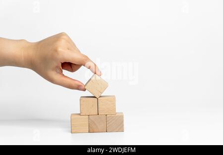 building wood blocks on white background; business or creative concept Stock Photo