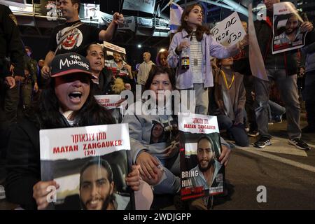 Ilana Gritzewsky, 30, who was released two months ago from Gaza as part of a temporary pause in fighting with Hamas, holds a poster with the photo of her boyfriend, Matan Zangauker, who is held in Gaza as families of Israeli hostages block a major motorway outside the Defense Ministry during a demonstration calling for a deal to free Israeli hostages held in the Gaza Strip on January 20, 2024 in Tel Aviv, Israel. Stock Photo