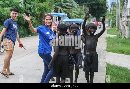 Laguna, Philippines. Jan 21, 2024: Children wearing black makeup (Ati-Atihan) during celebrations of Sto. Niño feast. Festivities include processions, masses, street dancing and Ati-Atihan, which are regularly controversial because compared to Western caricatural blackface. However, this old Filipino tradition has no relation and is not offensive. While similar in gesture, performers of Ati-Atihan Festival wear black soot to pretend to as Atis, honoring dark-skinned indigenous peoples, who historians believed to be the first inhabitants of the Philippines. Credit: Kevin Izorce/Alamy Live News Stock Photo