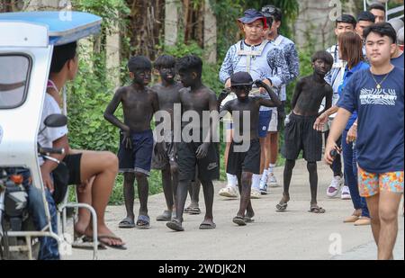 Laguna, Philippines. Jan 21, 2024: Children wearing black makeup (Ati-Atihan) during celebrations of Sto. Niño feast. Festivities include processions, masses, street dancing and Ati-Atihan, which are regularly controversial because compared to Western caricatural blackface. However, this old Filipino tradition has no relation and is not offensive. While similar in gesture, performers of Ati-Atihan Festival wear black soot to pretend to as Atis, honoring dark-skinned indigenous peoples, who historians believed to be the first inhabitants of the Philippines. Credit: Kevin Izorce/Alamy Live News Stock Photo