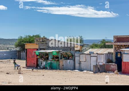 Nkoilale, Kenya - Village shops in the village of Nkoilale, Narok County, Kenya. Corrugated tin shacks form vegetable shops, and livestock wanders in Stock Photo