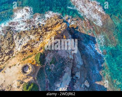 Aerial view of Porto Ferro tower surrounded by turquoise water. Sardinia, Italy Stock Photo