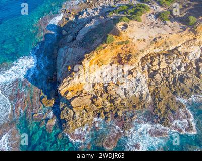 Aerial view of Porto Ferro tower surrounded by blue water. Sardinia, Italy Stock Photo