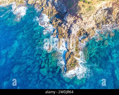 Aerial view of rough sea by a rocky shore in Sardinia, Italy Stock Photo