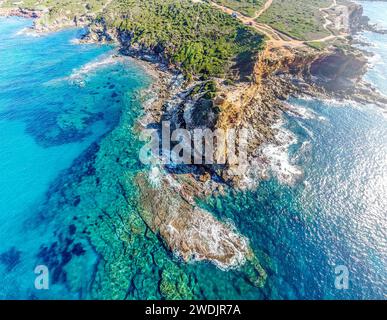 Aerial view of turquoise water and rocks in Porto Ferro coastline. Sardinia, Italy Stock Photo