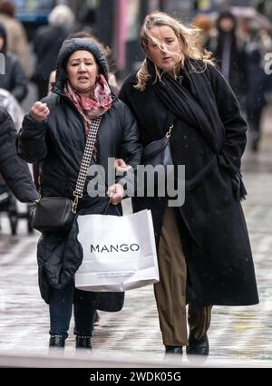 Women in windy conditions in Leeds. The UK is blanketed by 'unusual' danger-to-life wind warnings ahead of Storm Isha, with people warned not to travel amid possible 90mph gusts. Picture date: Sunday January 21, 2024. Stock Photo