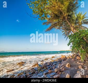 Dark sand in Grand Anse beach in Guadeloupe, French west indies. Lesser