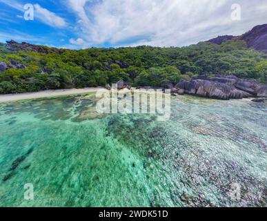 Aerial view of world famous Anse Source d'Argent beach on a cloudy day. La Digue island, Seychelles Stock Photo