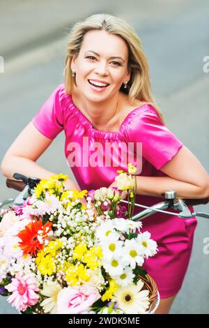 Beautiful bouquet of flowers in basket on wooden background, Valentines ...