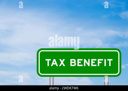Green color transportation sign with word tax benefit on blue sky with white cloud background Stock Photo