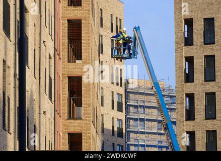 Scissor lift being operated by construction workmen for safe access at height Stock Photo