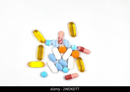 Pills and colorful medical capsules on white background. Stock Photo