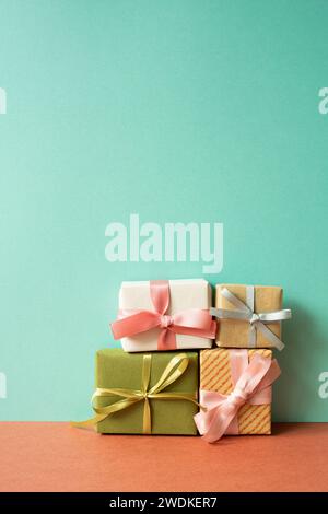 Colorful gift box on red table. mint green wall background Stock Photo