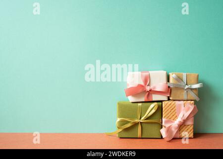 Colorful gift box on red table. mint green wall background Stock Photo