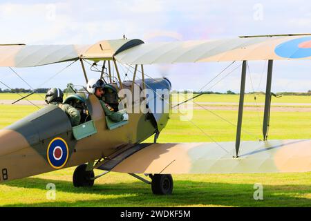De Haviland DH82B Queen Bee Tiger Moth, G-BLUZ, from behind as it taxis out for take off from RAF Syerston, Nottinghamshire. Stock Photo