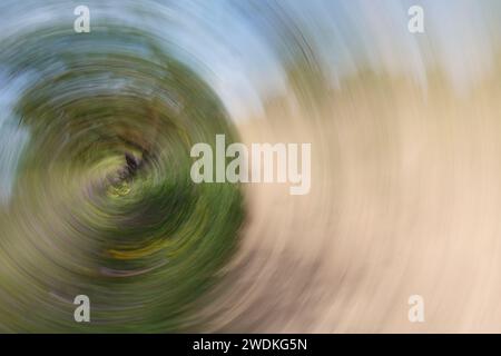 Spring turns to summer cycle of seasons abstract landscape swirl motion blur.  Intentional camera movement. Stock Photo