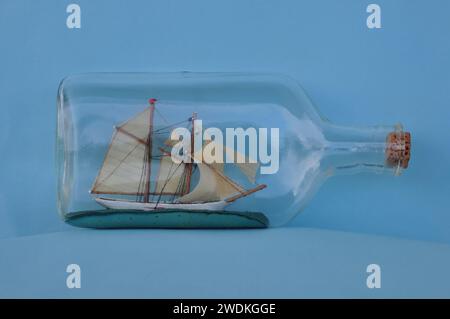 Vintage impossible bottle sailing ship with masts and sails. Stock Photo